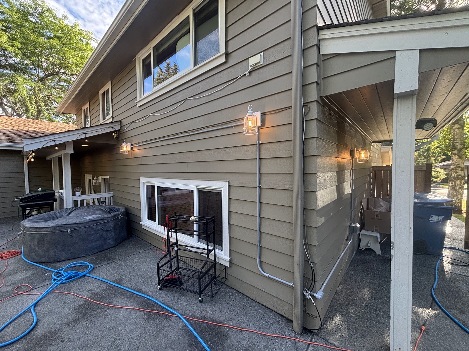 Exterior electrical equipment and conduit along a house
