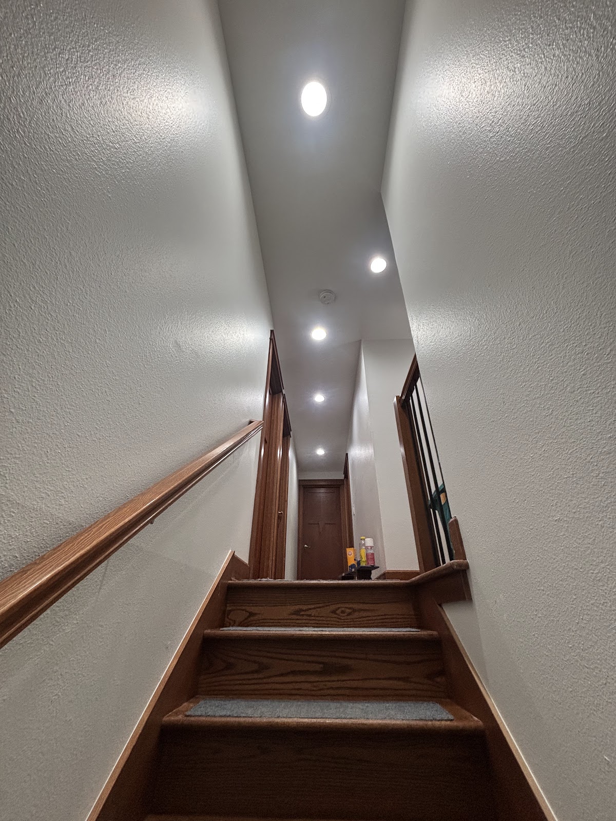 Residential hallway and stairway with recessed lights