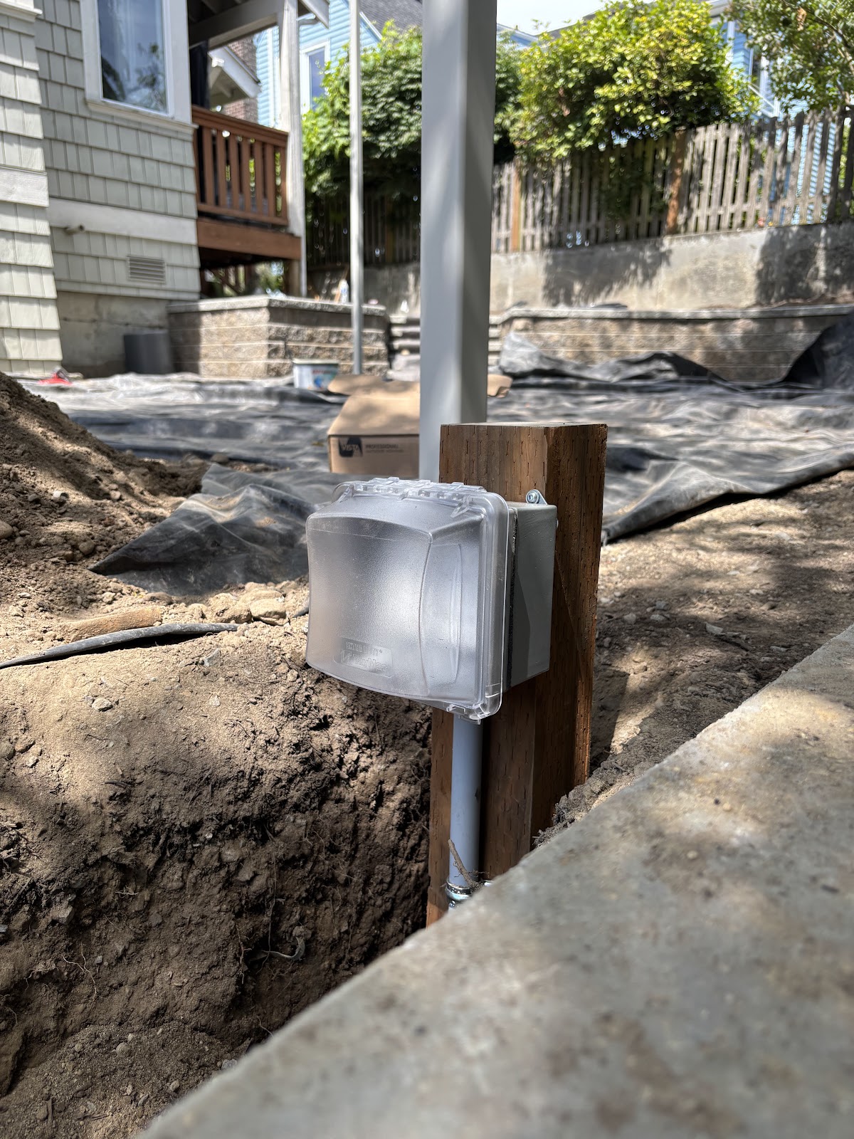 Open electrical trench beside exterior equipment