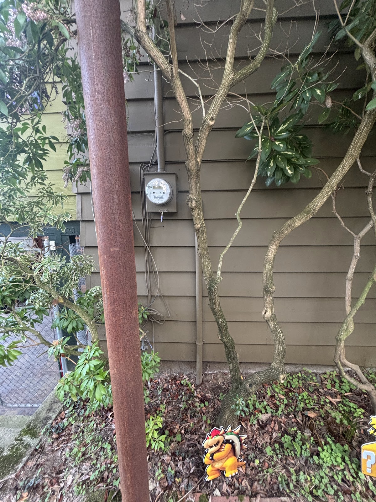 Electrical meter equipment beside a residential wall