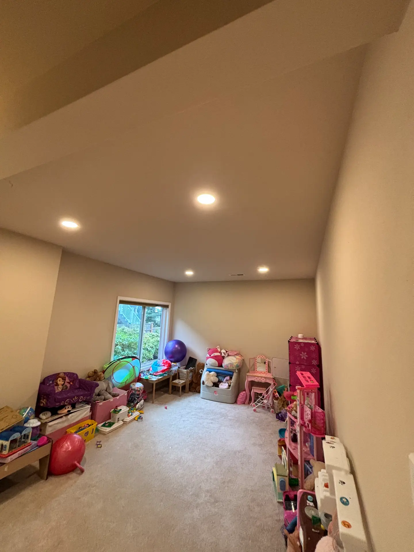 Illuminated recessed ceiling lights in a residential family playroom