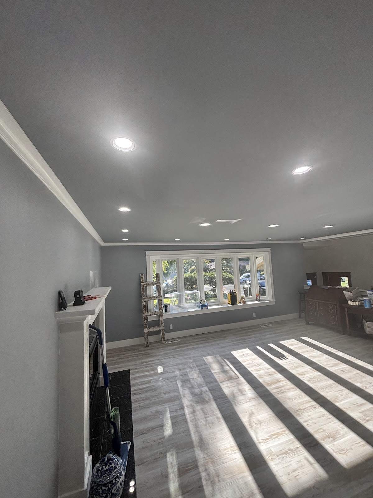 Long residential room with recessed ceiling lights